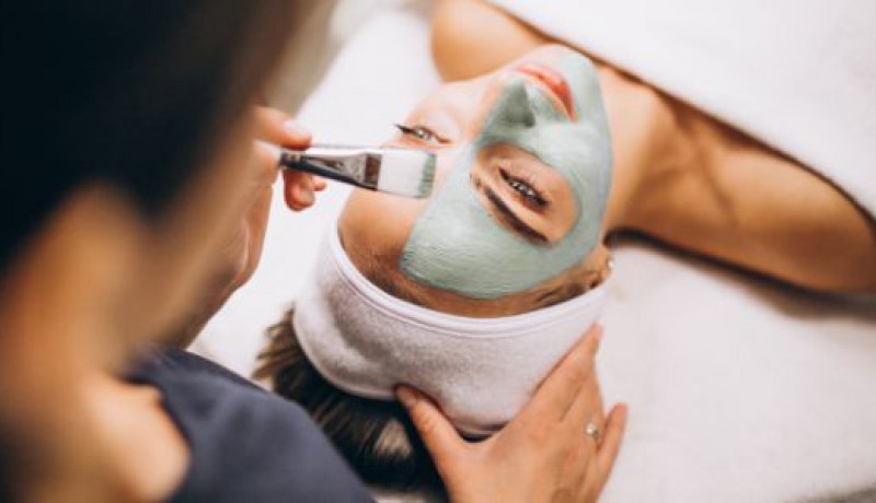 cosmetologist applying mask face client beauty salon 1